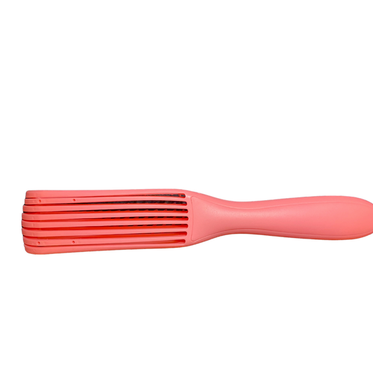Pink hairbrush with a ribbed design on a white background