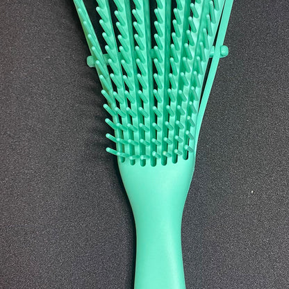 Green hairbrush on a dark gray background