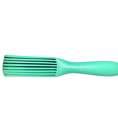 Green hairbrush on a white background