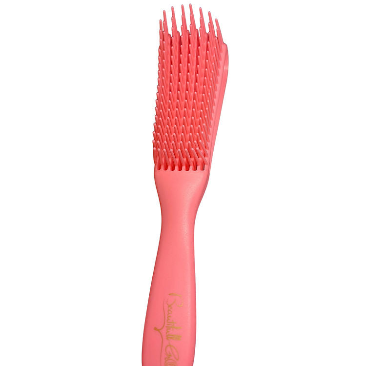Pink hairbrush with textured bristles on a white background